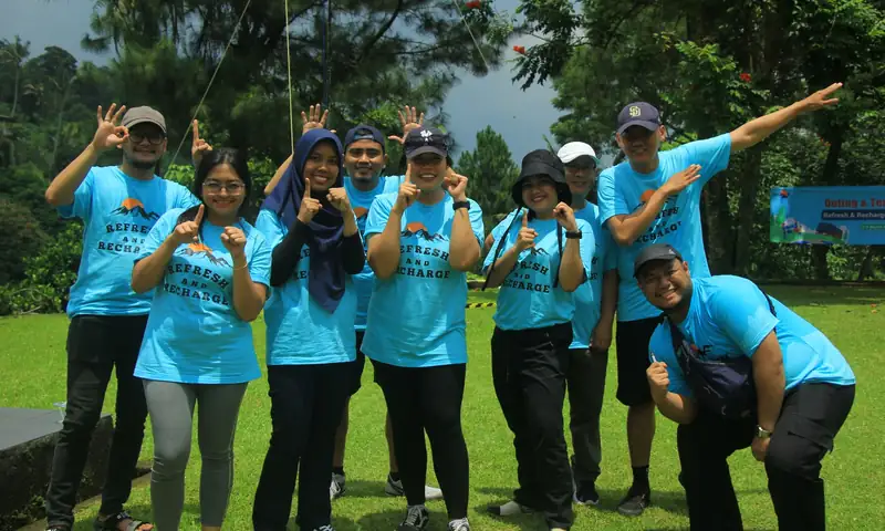 Rombongan peserta gathering perusahaan berfoto di area hijau Villa Bukit Pancawati Bogor